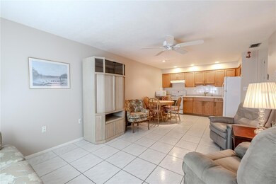 Step into a bright, open living space where the kitchen and living area flow seamlessly together, creating a welcoming and airy atmosphere. Sunlight fills the room, highlighting the spacious layout that’s perfect for entertaining friends, enjoying family time, or simply relaxing in comfort. The open design invites connection and easy movement, making the heart of the home both functional and inviting.