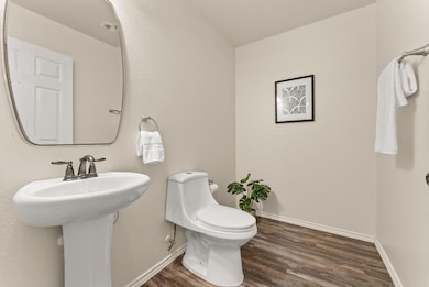 Bathroom with wood finished floors and toilet
