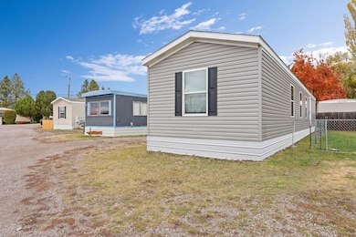 Pristine Greystone single-wide home on Lot 17 with crisp white skirting and black shutters
