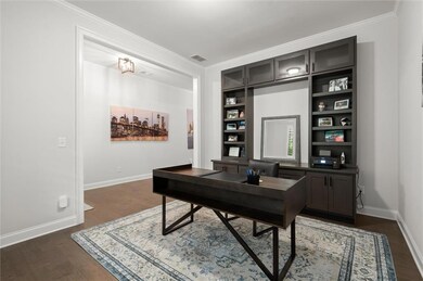 Bright and quiet main-level office with custom built-ins—ideal for working from home.