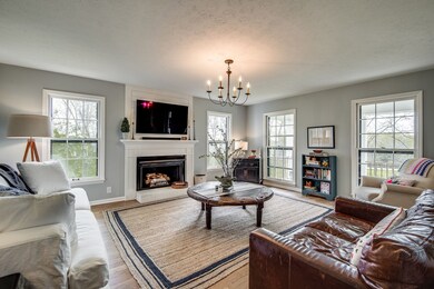 Large sunny great room with new gas fireplace mantel and wood floors. New windows thru out! 