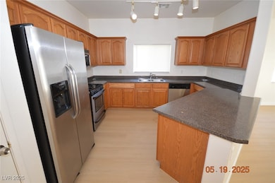 Kitchen featuring stainless steel appliances, dark