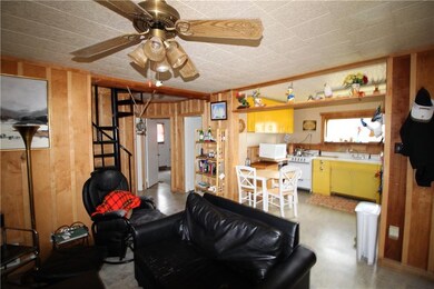 View of living room. The spiral staircase in the c