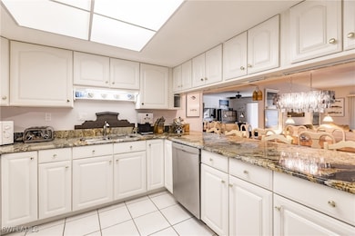 Kitchen with dishwasher, white cabinets, ceiling f