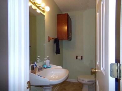 Guest bath offers a large shower and pedestal sink.