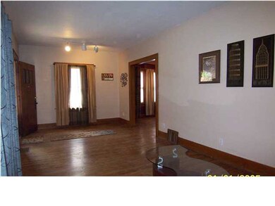 Large family room with beautiful wood floors and w