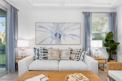 Living room featuring tile patterned flooring and a raised ceiling