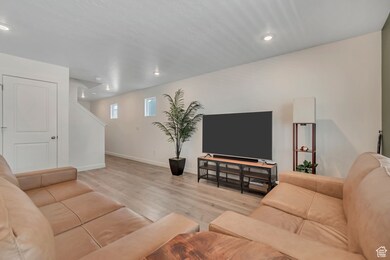 Living room featuring light wood-style floors and recessed lighting