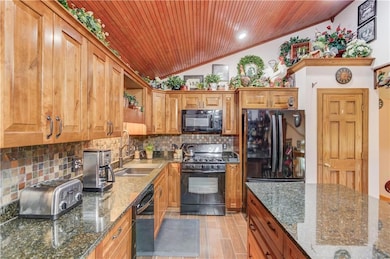 Kitchen with vaulted ceiling, wooden ceiling, a si