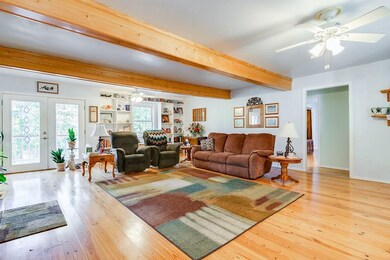 Spacious family room with lots of natural light.  Views of beautifully landscaped front and backyards.  Wrap-around porches on all sides of the house.