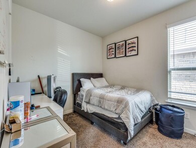 Bedroom featuring multiple windows and carpet floo