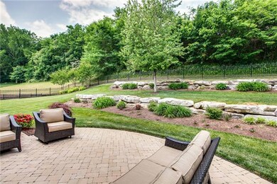 Outdoor entertaining this summer will be so fun in this professionally landscaped backyard and stone patio.  