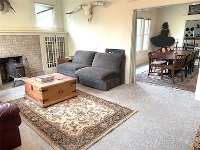 Carpeted living area with a wood stove