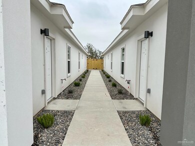 View of side of property featuring fence and stucco siding