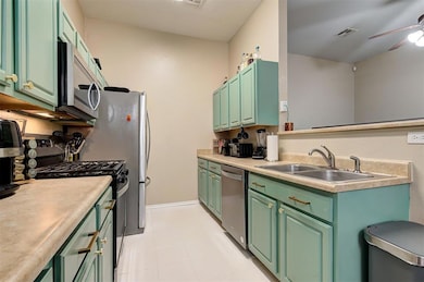 Kitchen with ceiling fan, stainless steel applianc