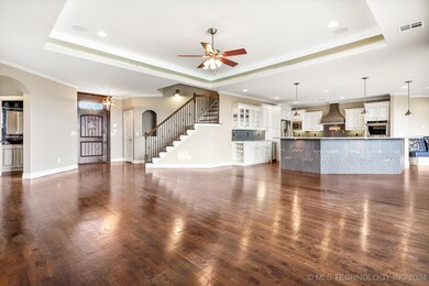 View from family room of kitchen. Stairs lead to a