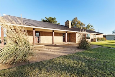 Rear view of property featuring a lawn