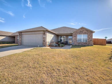Ranch-style house featuring roof with shingles, driveway, and brick siding