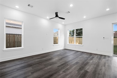 Bright and open living area filled with natural light, seamlessly connecting to the kitchen for everyday living and entertaining