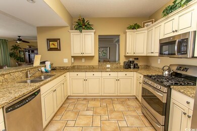 Kitchen with ceiling fan, sink, light tile pattern