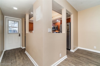 Hallway with dark wood-type flooring