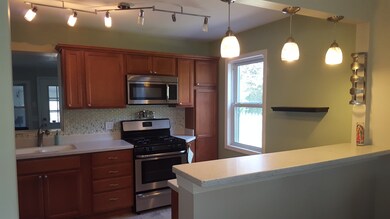 Kitchen has stainless appliances, corian counters 