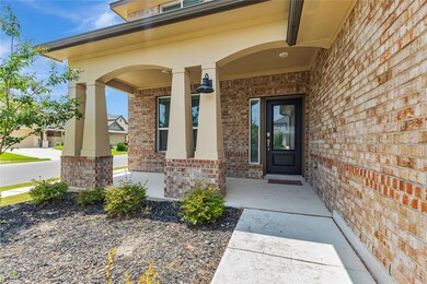 View of exterior entry featuring brick siding and