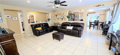 Living area featuring ceiling fan, recessed lighting, and light tile patterned floors