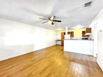 Unfurnished living room with baseboards, a textur
