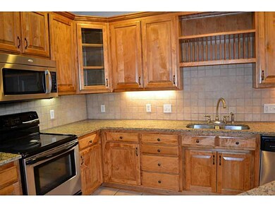 Kitchen. Glass cabinets for your special pieces as well as a plate rack.