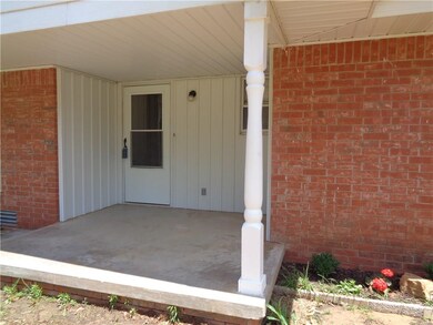 Covered front porch with storm door.