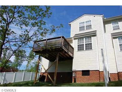 Exterior Back - End unit backing to woods and lake