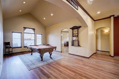 Living room with cathedral ceiling, arched doorway