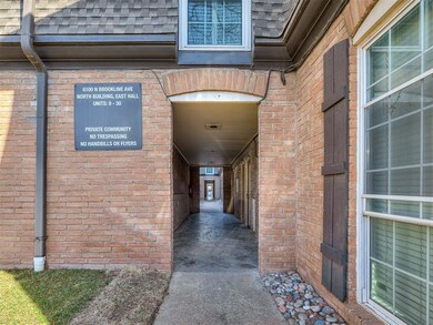 View of exterior entry featuring a shingled roof a