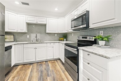 Kitchen remodeled with recessed lighting and updated flooring.