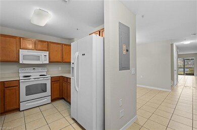 Kitchen with window above sink, white appliances, 