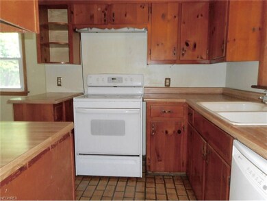 Knotty pine cabinets are in the kitchen with ceram