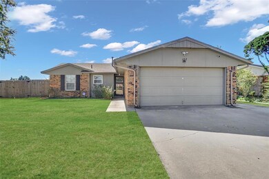 Single story home with a garage and a front lawn