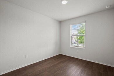 Empty room with dark wood finished floors and bas