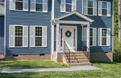 View of exterior entry with a lawn