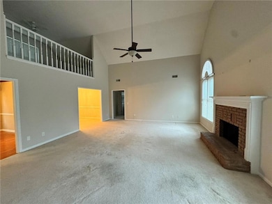 Unfurnished living room featuring ceiling fan, lig