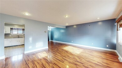 Unfurnished room with light hardwood / wood-style flooring and sink