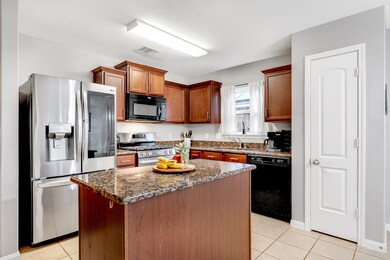 Granite island kitchen with pantry.