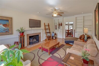Family room has gas fireplace logs and built-in bo