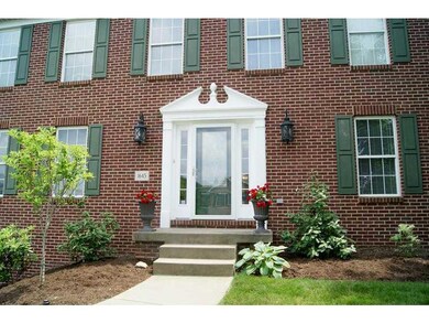Exterior Front. The stately entrance features a le