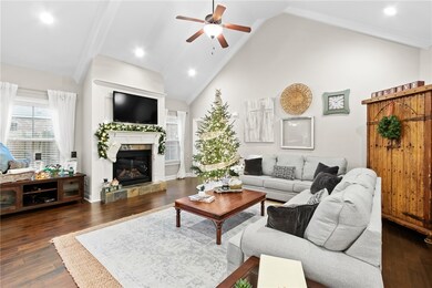 A vaulted ceiling, gas fireplace, wood floors, and