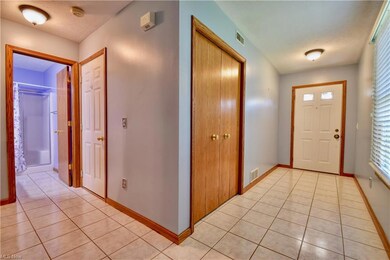 Foyer featuring a textured ceiling and light tile 