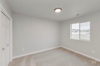 Unfurnished bedroom with light colored carpet and a closet