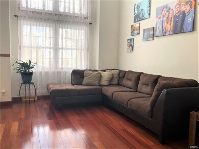 Front living room with Brazilian hardwood floors, cathedral ceilings and open to the dining room.
