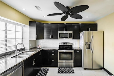 Kitchen with stainless steel appliances, backsplas